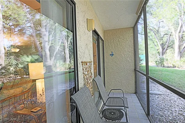 a view of a door and chair in the balcony