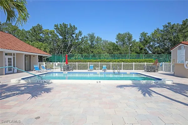 a view of a house with backyard and a sitting area