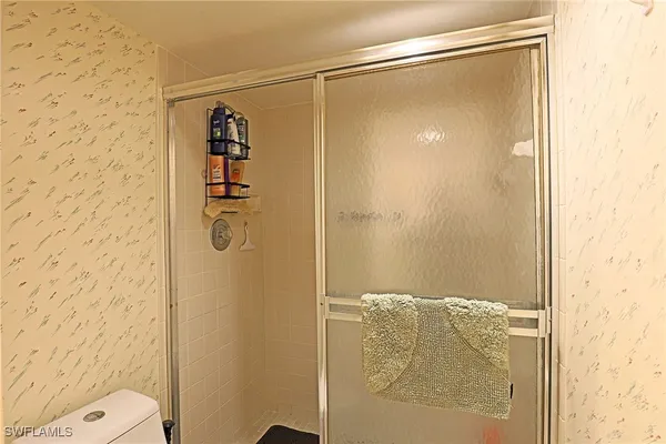 a bathroom with a shower and a toilet