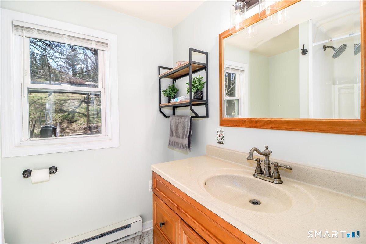 61 Pumpkin Hill Road New Milford, CT 06776 - Photo 11 of 40 a bathroom with a sink and a mirror