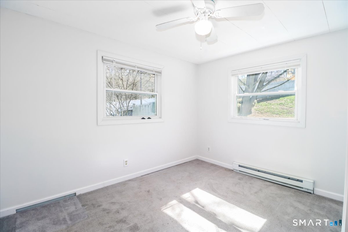 61 Pumpkin Hill Road New Milford, CT 06776 - Photo 12 of 40 an empty room with a window and a ceiling fan