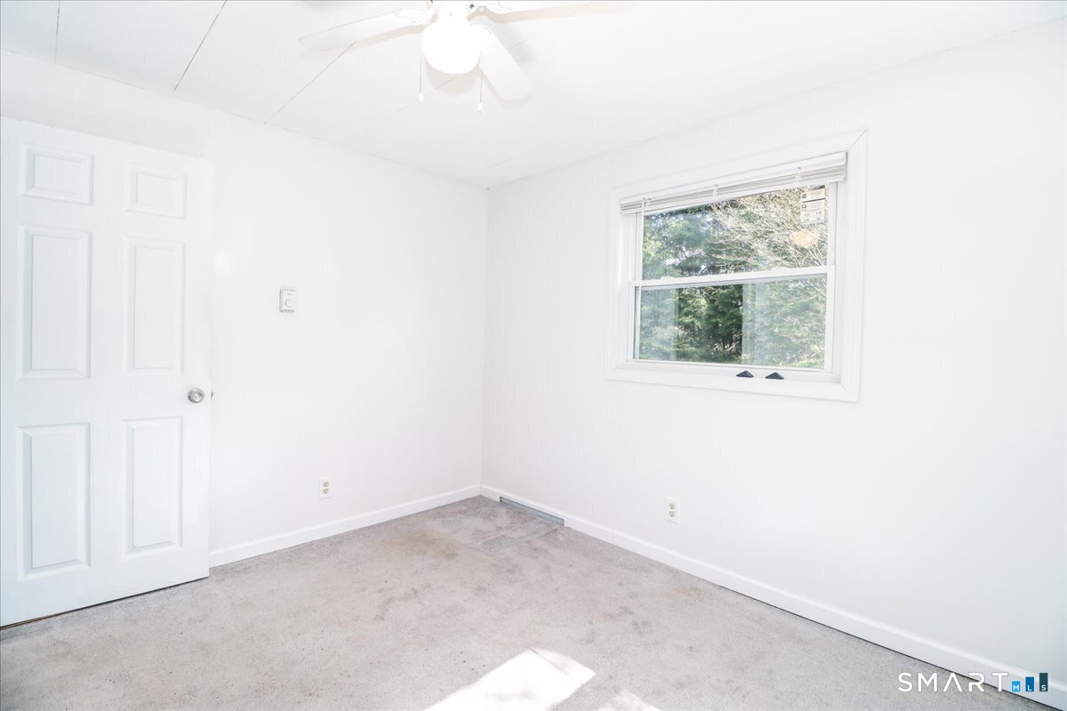 61 Pumpkin Hill Road New Milford, CT 06776 - Photo 13 of 40 an empty room with a window