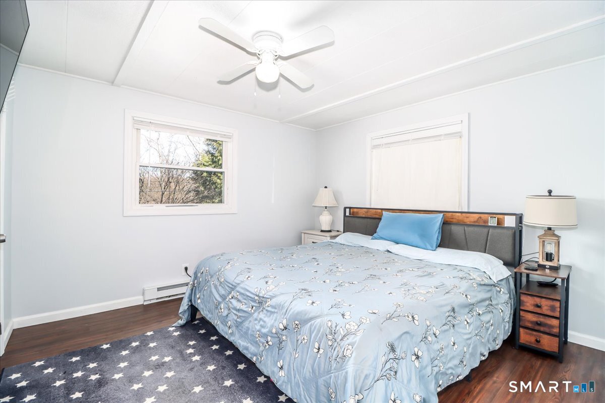 61 Pumpkin Hill Road New Milford, CT 06776 - Photo 14 of 40 a bedroom with a bed and a chandelier