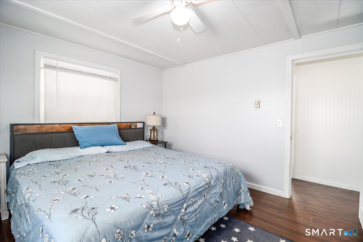 61 Pumpkin Hill Road New Milford, CT 06776 - Photo 15 of 40 a bedroom with a bed and a chandelier