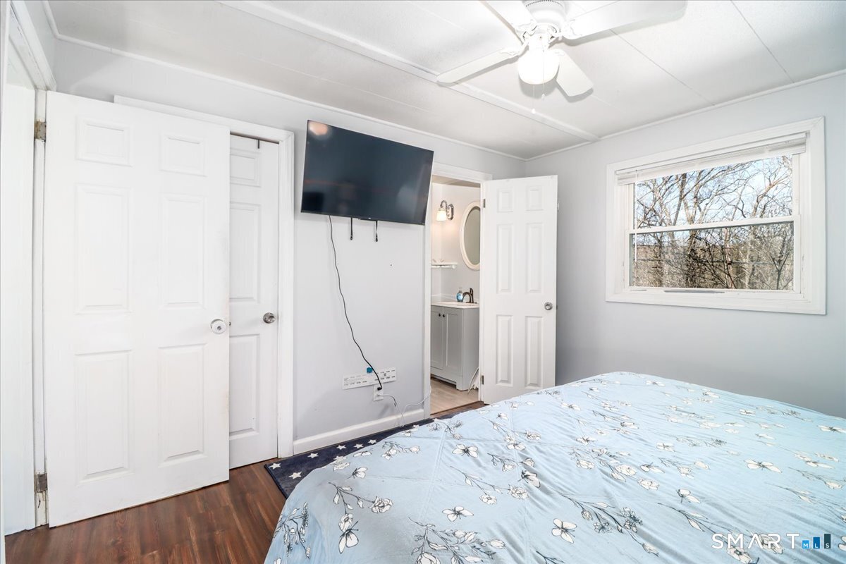 61 Pumpkin Hill Road New Milford, CT 06776 - Photo 16 of 40 a bedroom with a bed and a flat screen tv