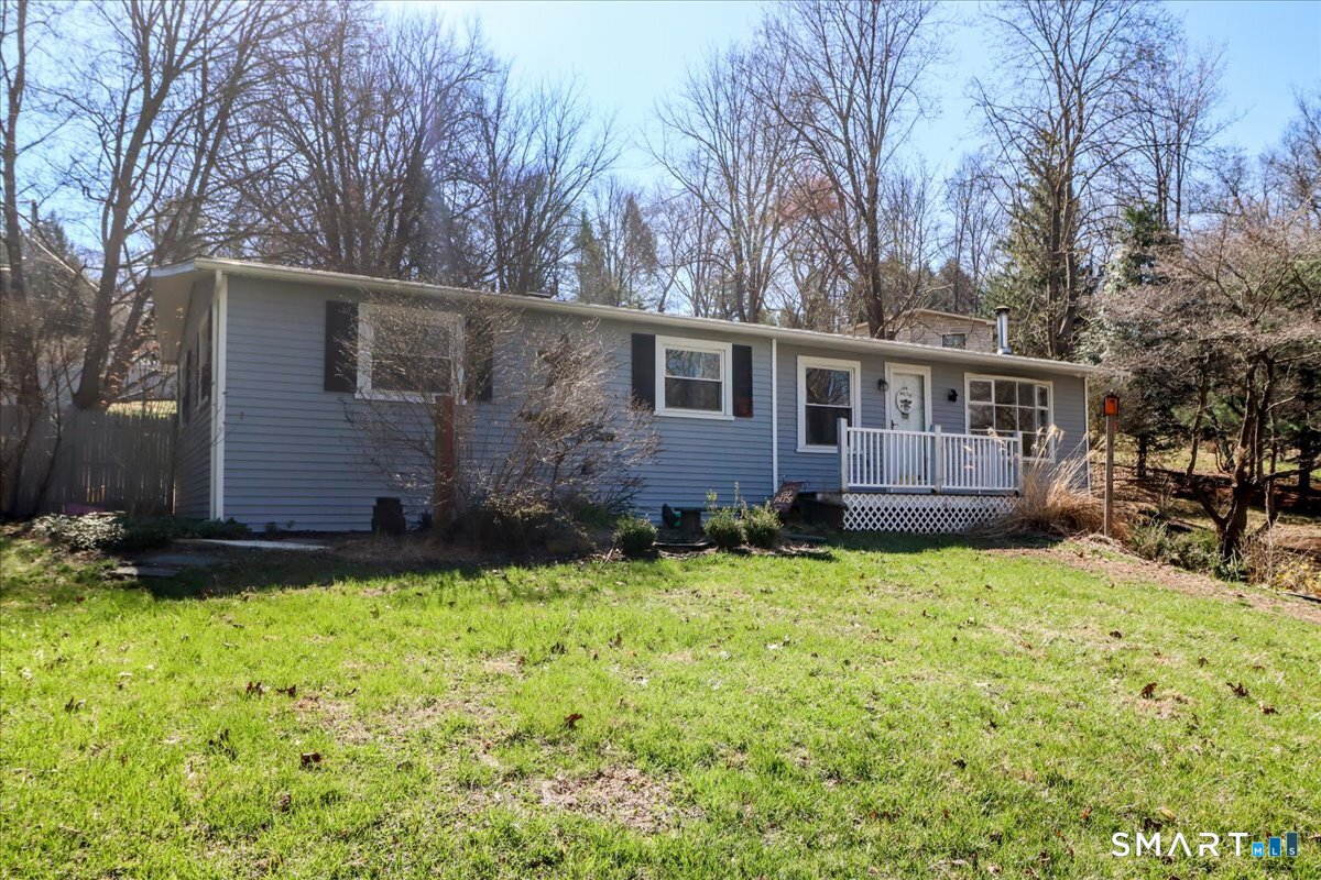 61 Pumpkin Hill Road New Milford, CT 06776 - Photo 2 of 40 a view of a backyard with plants and large tree