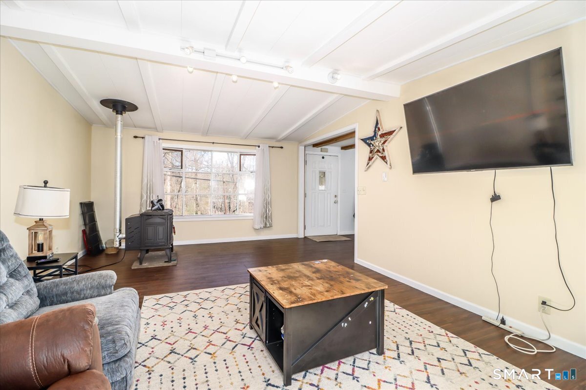 61 Pumpkin Hill Road New Milford, CT 06776 - Photo 22 of 40 a living room with furniture and a flat screen tv