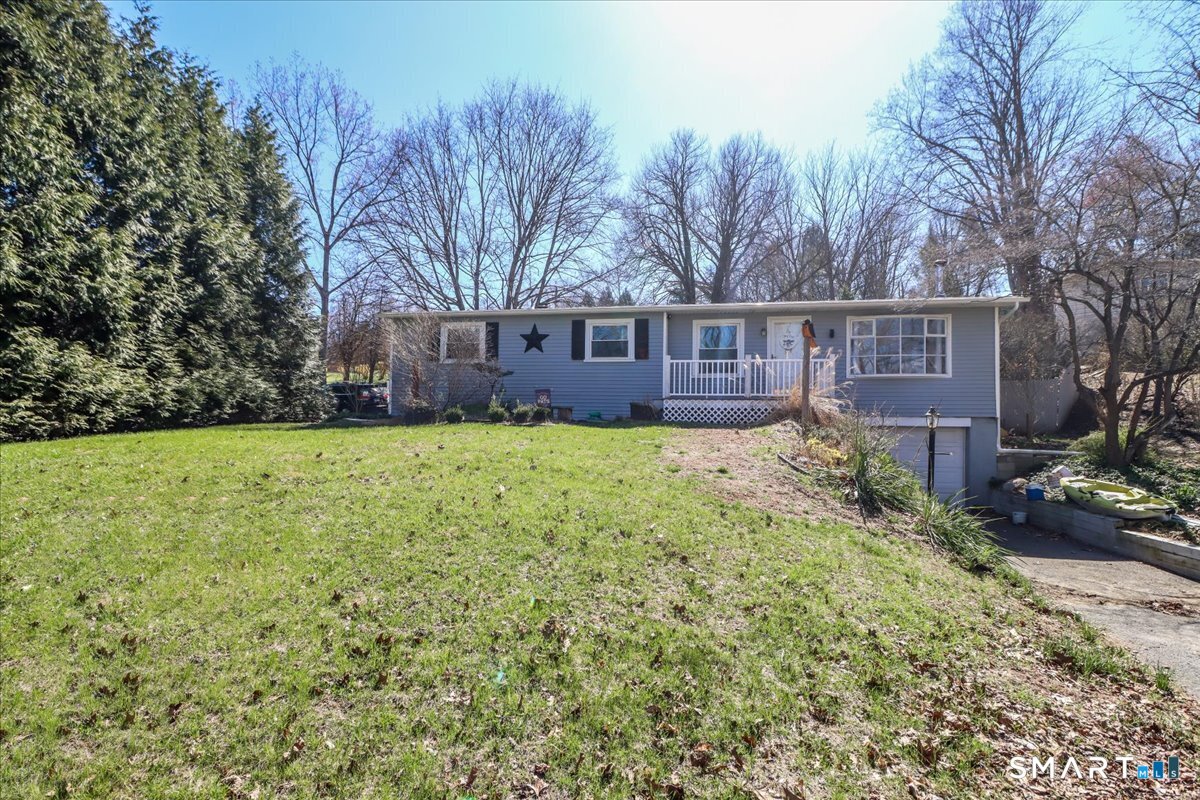 61 Pumpkin Hill Road New Milford, CT 06776 - Photo 30 of 40 a front view of house with yard and trees all around