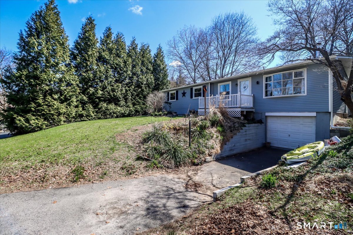 61 Pumpkin Hill Road New Milford, CT 06776 - Photo 3 of 40 a front view of a house with a yard