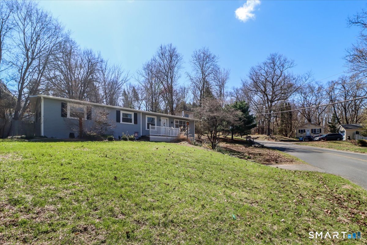 61 Pumpkin Hill Road New Milford, CT 06776 - Photo 31 of 40 a view of a backyard with a garden and trees