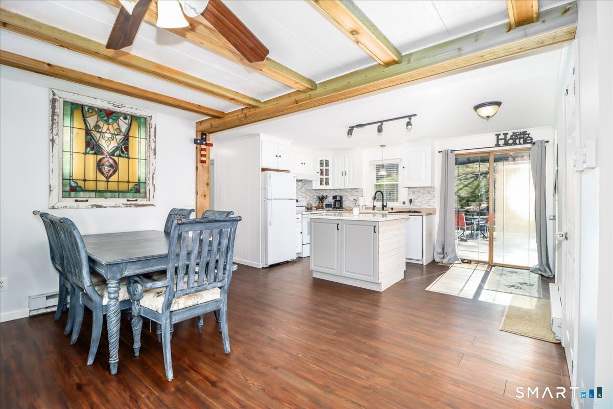 61 Pumpkin Hill Road New Milford, CT 06776 - Photo 5 of 40 a kitchen with stainless steel appliances kitchen island granite countertop a table chairs and a view of living room
