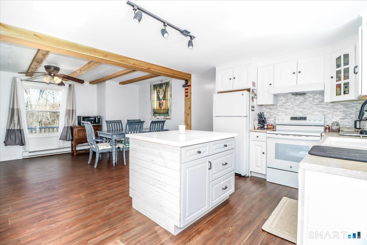 61 Pumpkin Hill Road New Milford, CT 06776 - Photo 6 of 40 a kitchen with white cabinets and white appliances