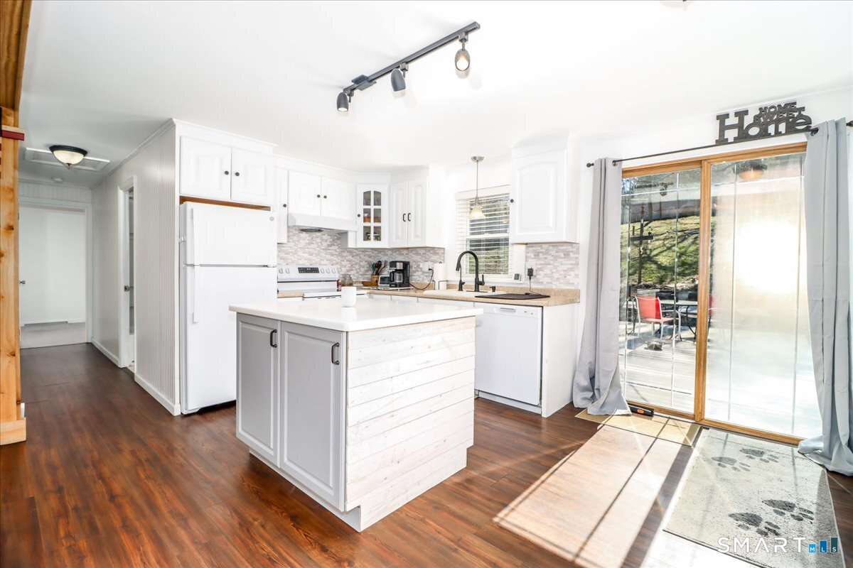 61 Pumpkin Hill Road New Milford, CT 06776 - Photo 7 of 40 a kitchen with refrigerator cabinets and wooden floor