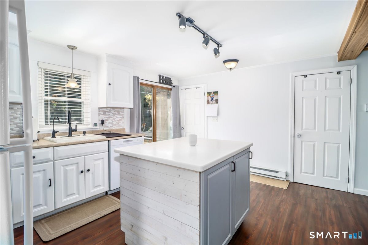 61 Pumpkin Hill Road New Milford, CT 06776 - Photo 9 of 40 a kitchen with a sink cabinets appliances and a window