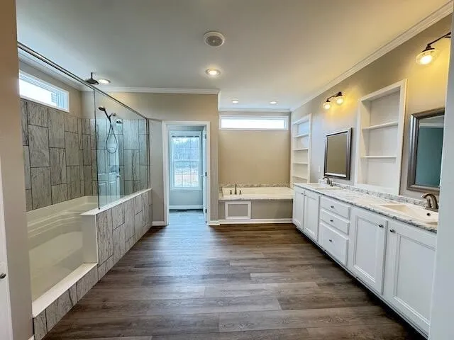 a large white bathroom with a large mirror vanity and shower