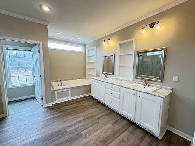 a large bathroom with double vanity and a large mirror