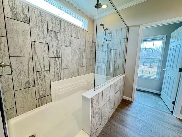 a view of a bathroom with shower and bathtub