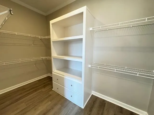 an empty room with a window and ceiling fan