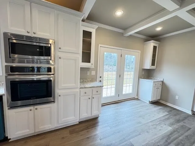 a kitchen with stainless steel appliances a stove a microwave and cabinets