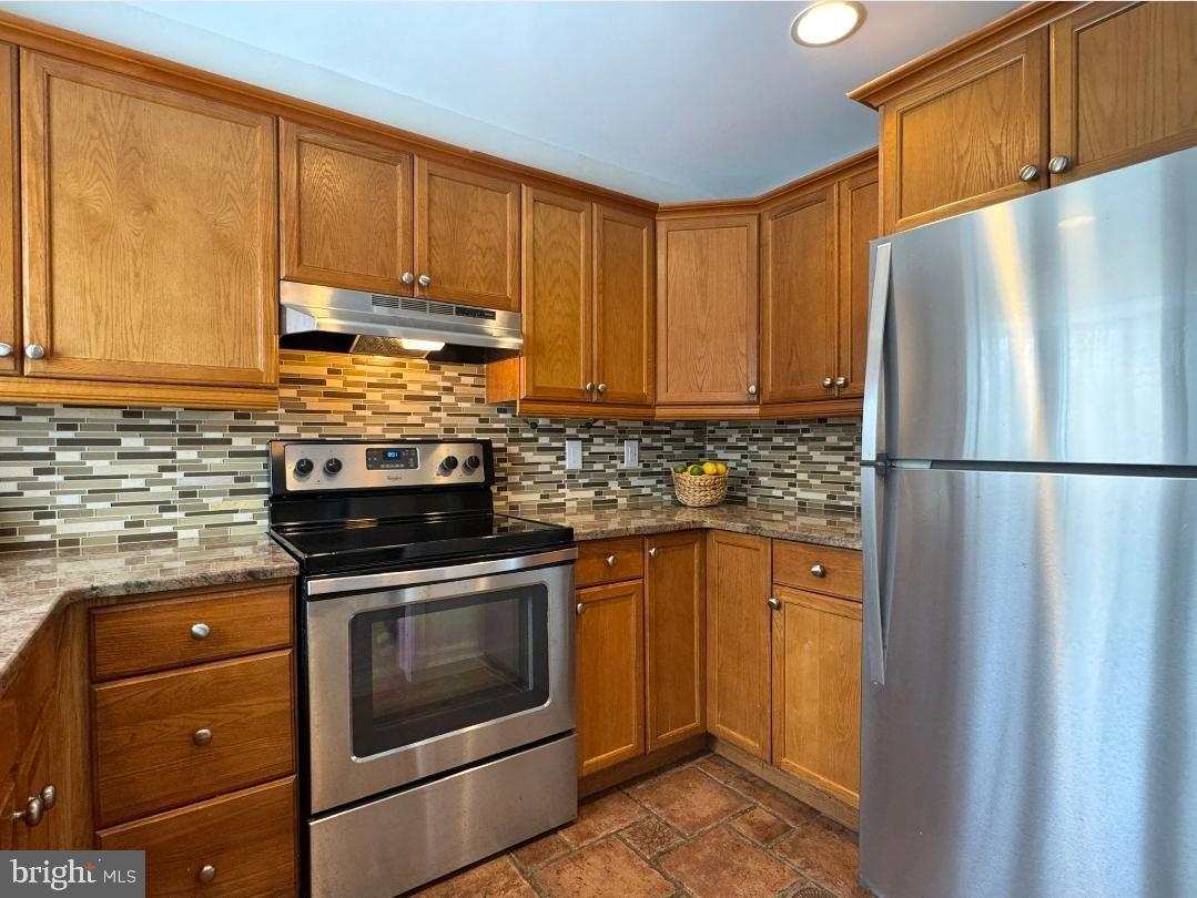 1105 Yardley Commons Yardley, PA 19067 - Photo 12 of 24 a kitchen with stainless steel appliances granite countertop a refrigerator stove and sink
