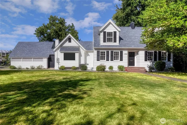 a front view of a house with a garden