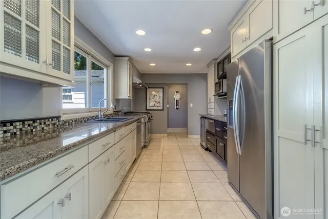 a large kitchen with stainless steel appliances lots of counter top space