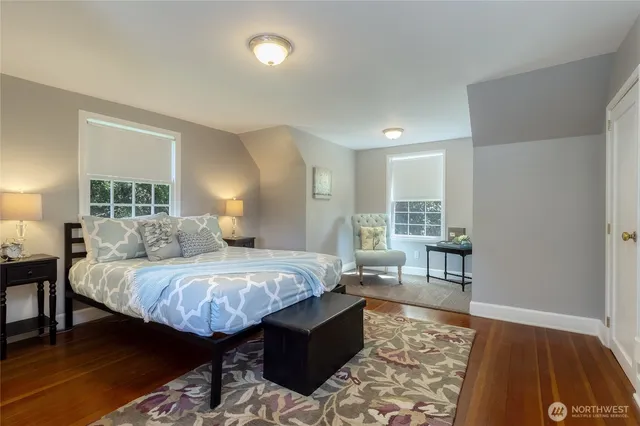 a bed room with a bed and wooden floor