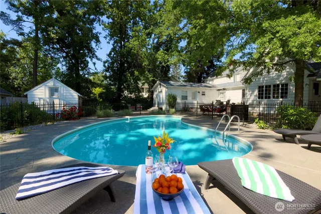 a view of a backyard with chairs and a garage