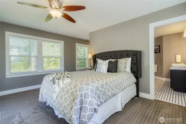 a bed sitting in a bedroom next to a window
