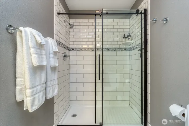 a bathroom with a shower and a mirror