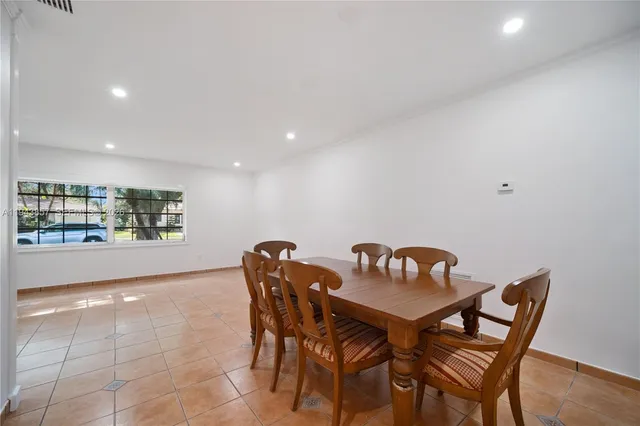 a view of a dining room with furniture and window