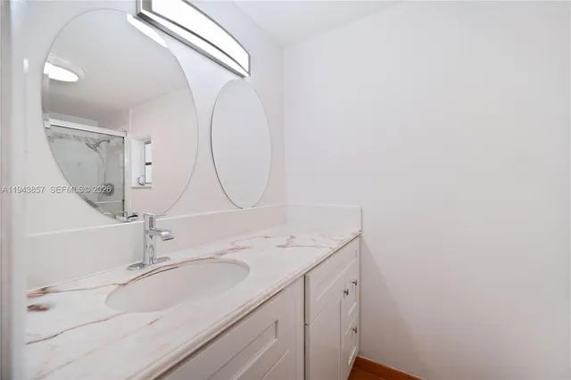 a bathroom with a sink and a mirror