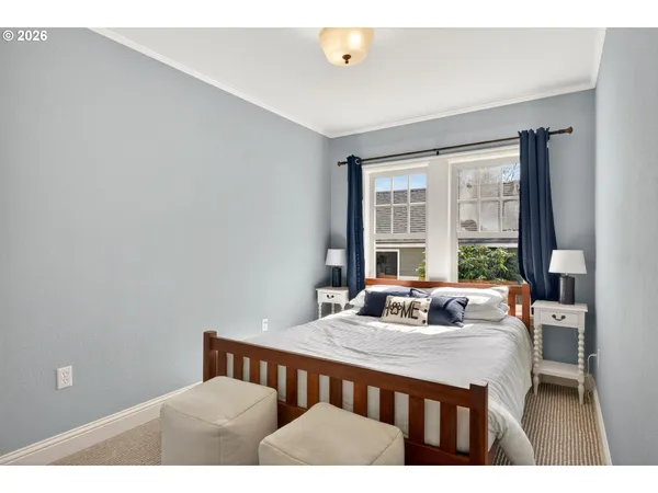 a bedroom with a bed and a large window