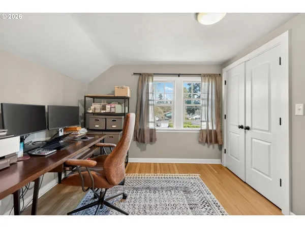 a view of a workspace with furniture and a window