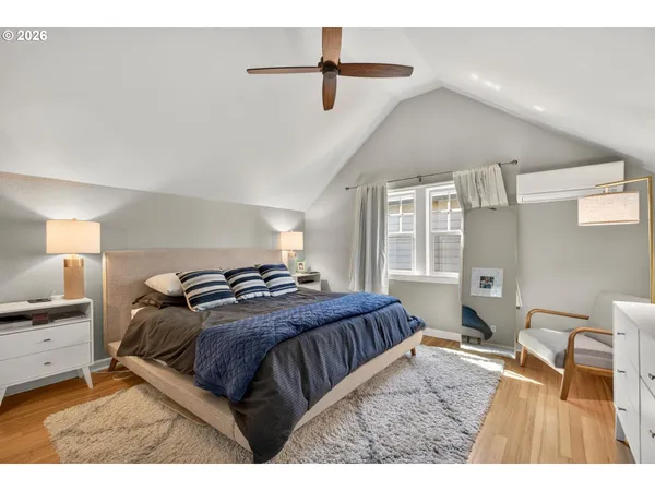 a bedroom with a bed next to a window with a chandelier