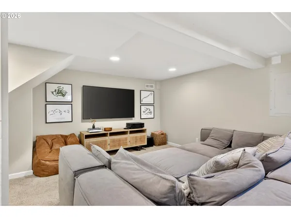 a bedroom with furniture and a flat screen tv