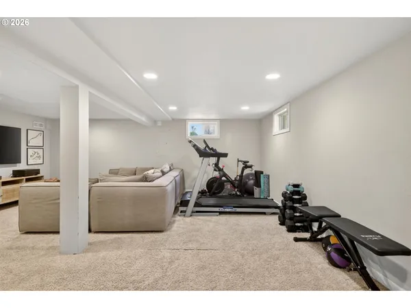 a room with gym equipment and a flat screen tv