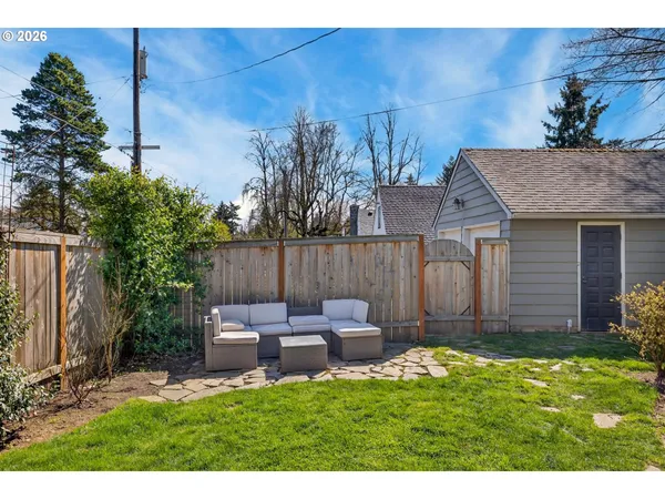 a backyard of a house with table and chairs