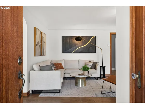 a living room with furniture and a painting on the wall