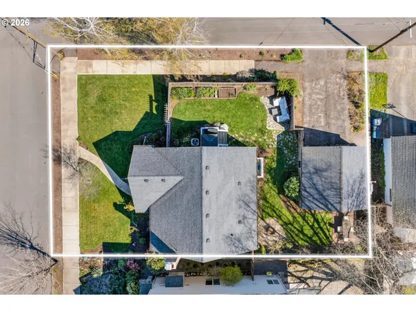 an aerial view of a house with a yard