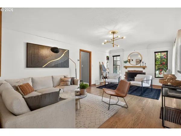 a living room with furniture a clock and a window