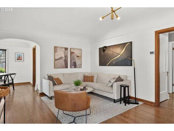 a living room with furniture and wooden floor