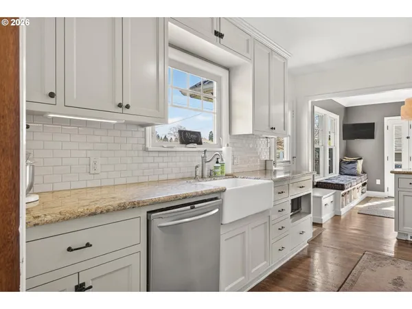 a kitchen with granite countertop white cabinets white appliances and granite countertops