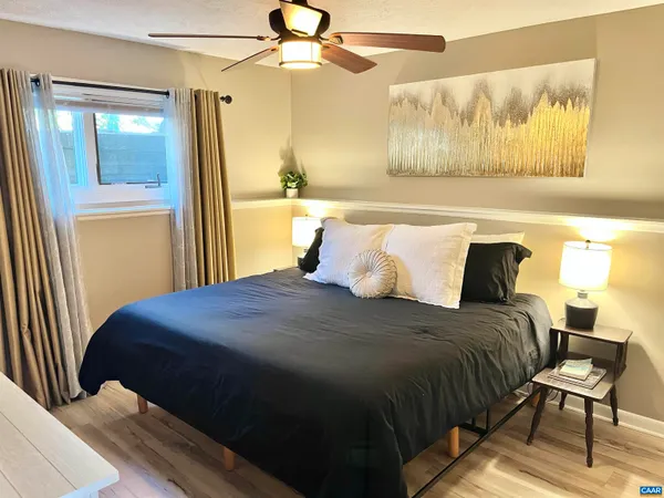 a bedroom with a bed and wooden floor