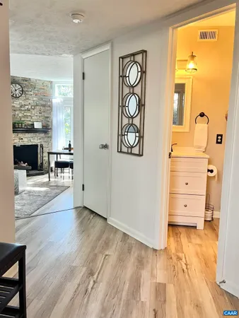a view of a hallway with wooden floor and windows