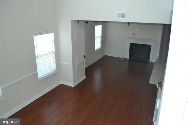 a kitchen with granite countertop a sink and a wooden floor