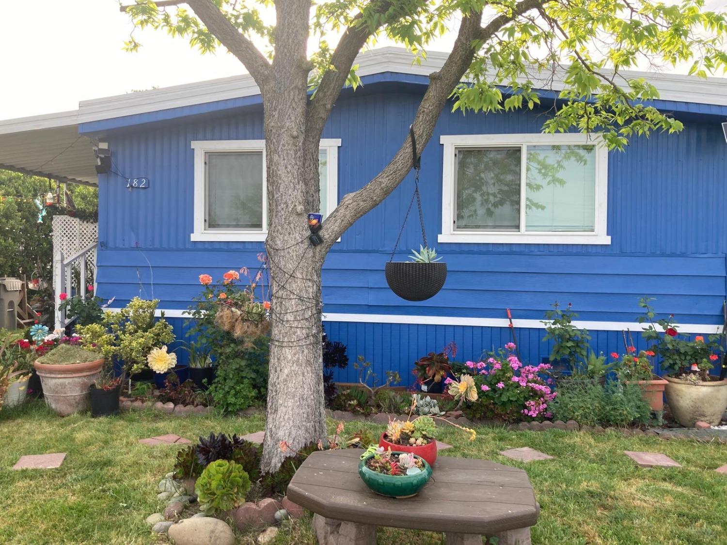 3950 Mack Road, Unit 182 Sacramento, CA 95823 - Photo 1 of 35 a front view of a house having a yard