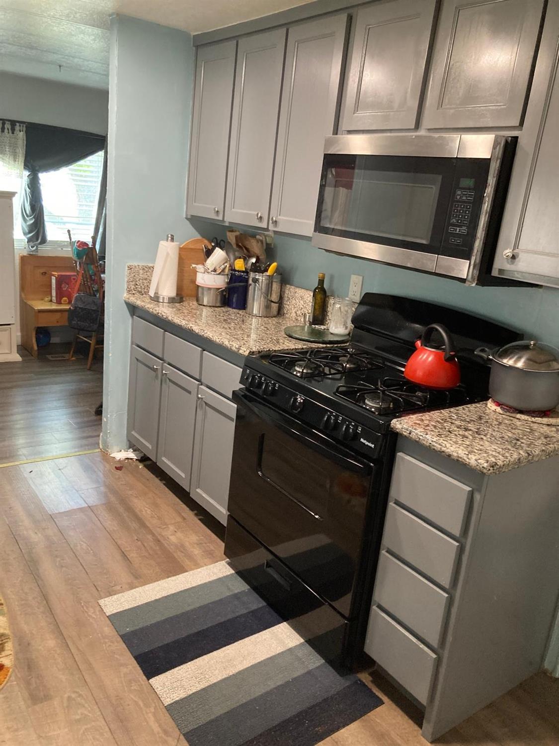 3950 Mack Road, Unit 182 Sacramento, CA 95823 - Photo 18 of 35 a kitchen with stainless steel appliances granite countertop a stove and a sink