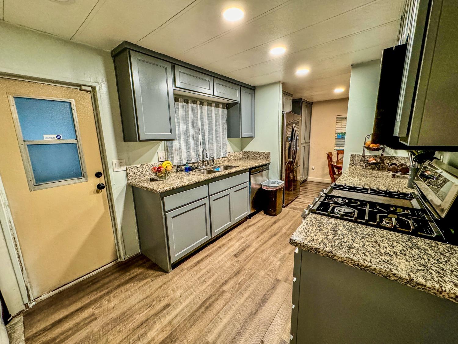 3950 Mack Road, Unit 182 Sacramento, CA 95823 - Photo 6 of 35 a kitchen with a stove a sink and a refrigerator