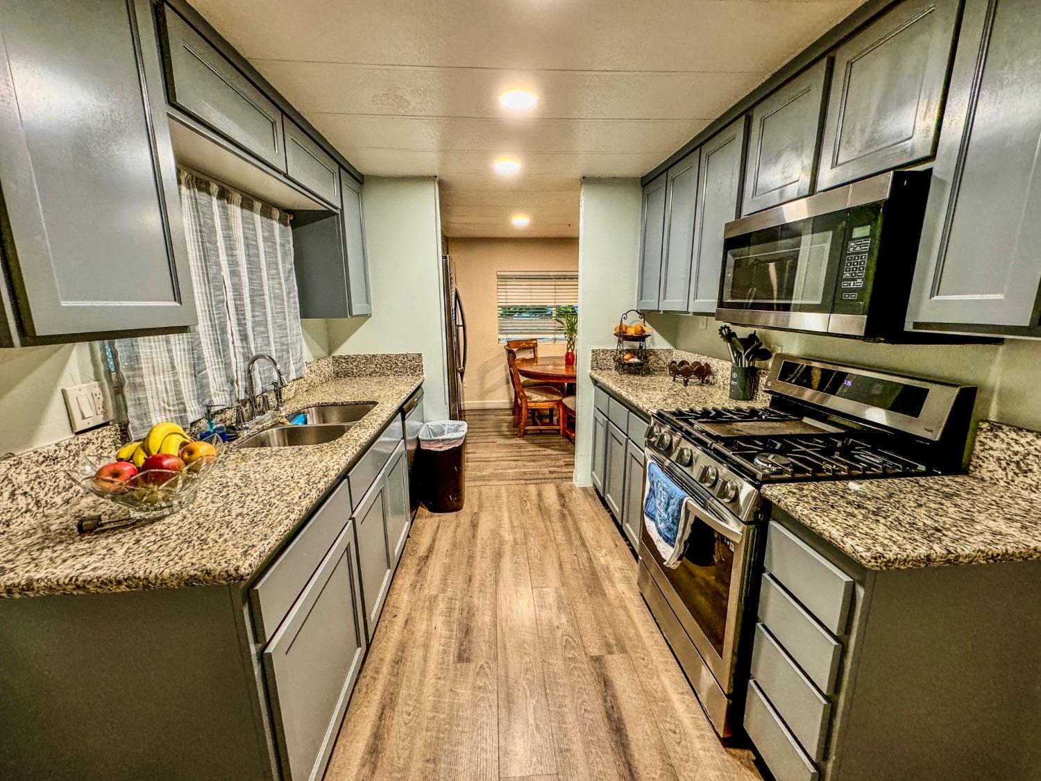 3950 Mack Road, Unit 182 Sacramento, CA 95823 - Photo 7 of 35 a kitchen with stainless steel appliances granite countertop a stove a sink dishwasher and a refrigerator